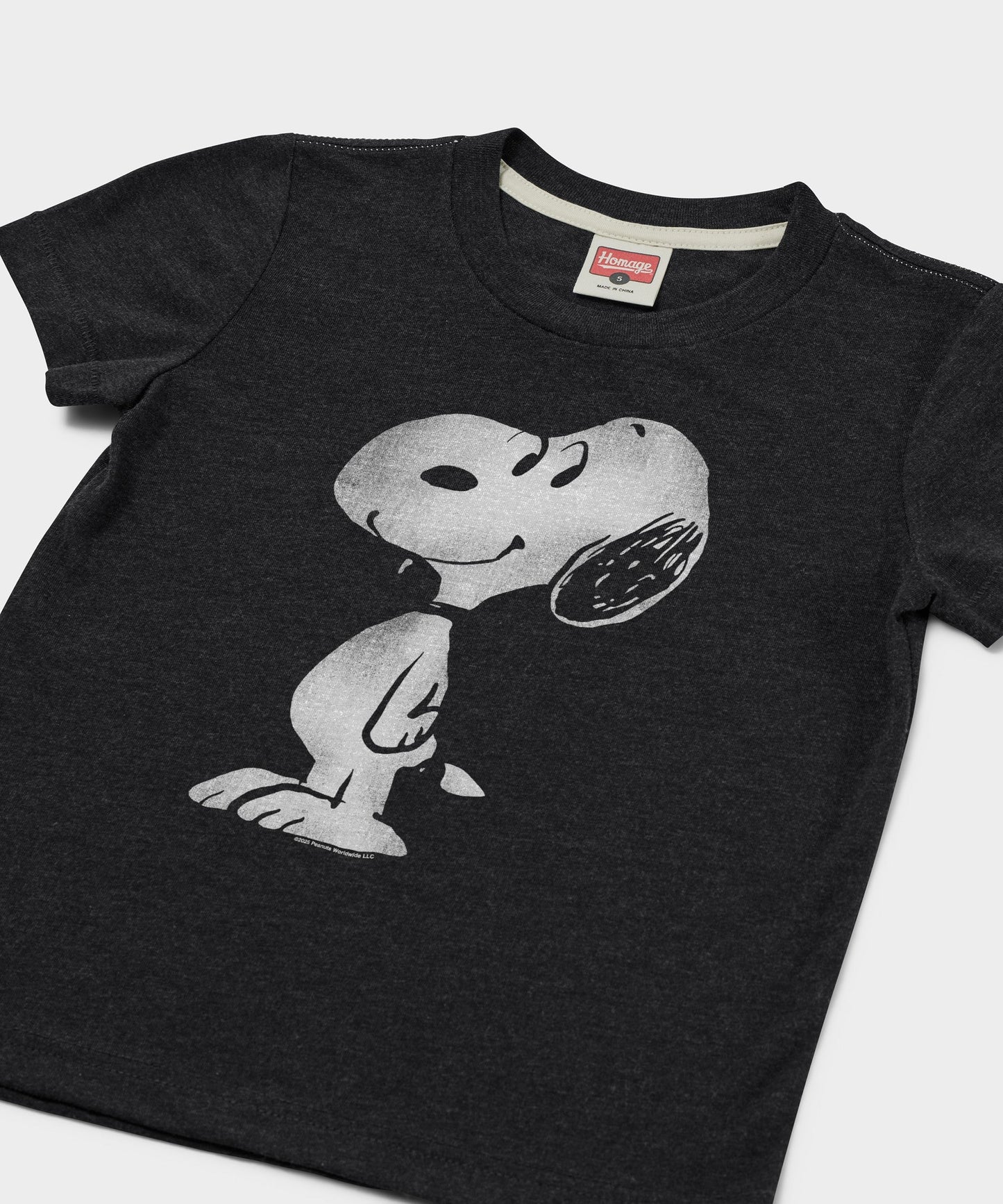 Close-up of the Snoopy graphic on the charcoal youth t-shirt