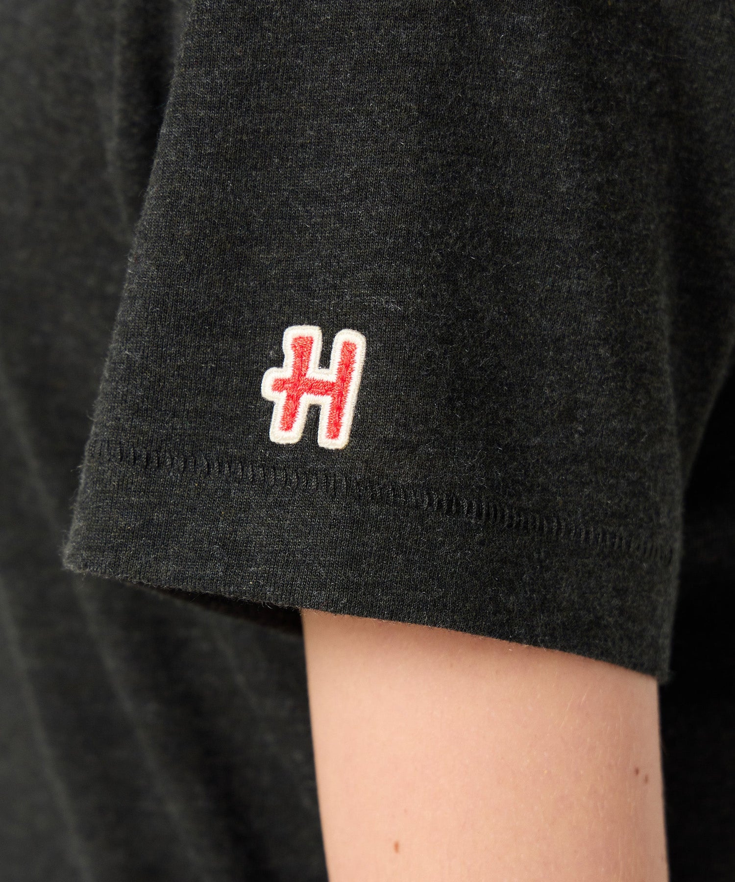 Folded charcoal youth t-shirt showing the soft cotton texture and graphic placement