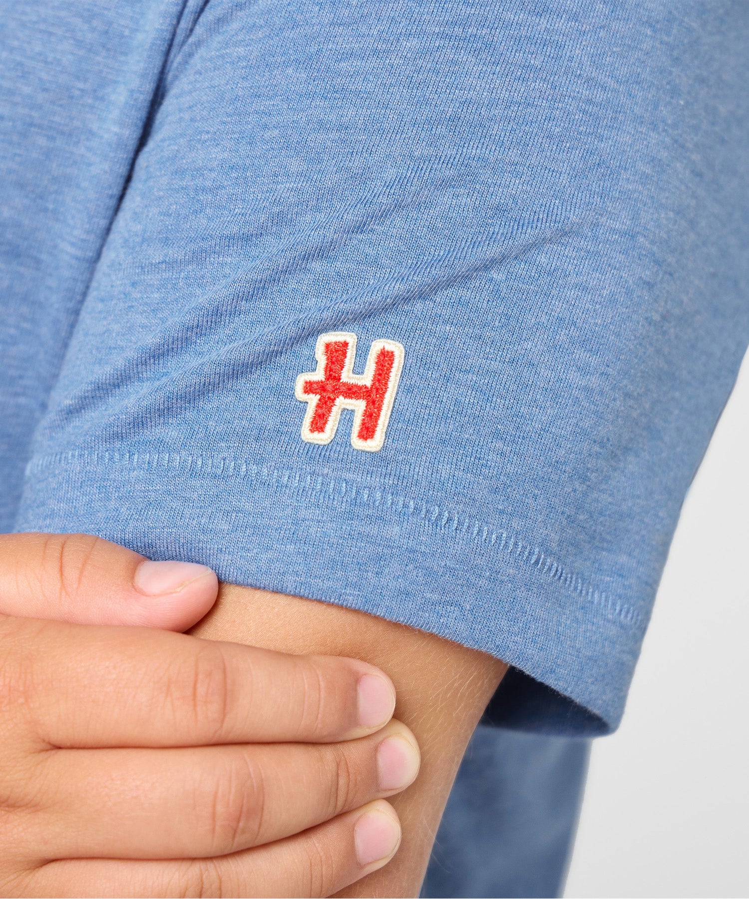 Folded light blue Peanuts youth t-shirt resting on a flat surface