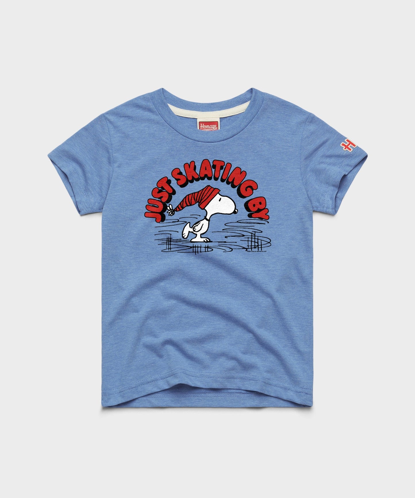 Light blue youth t-shirt featuring Snoopy skating across a frozen pond on the front chest