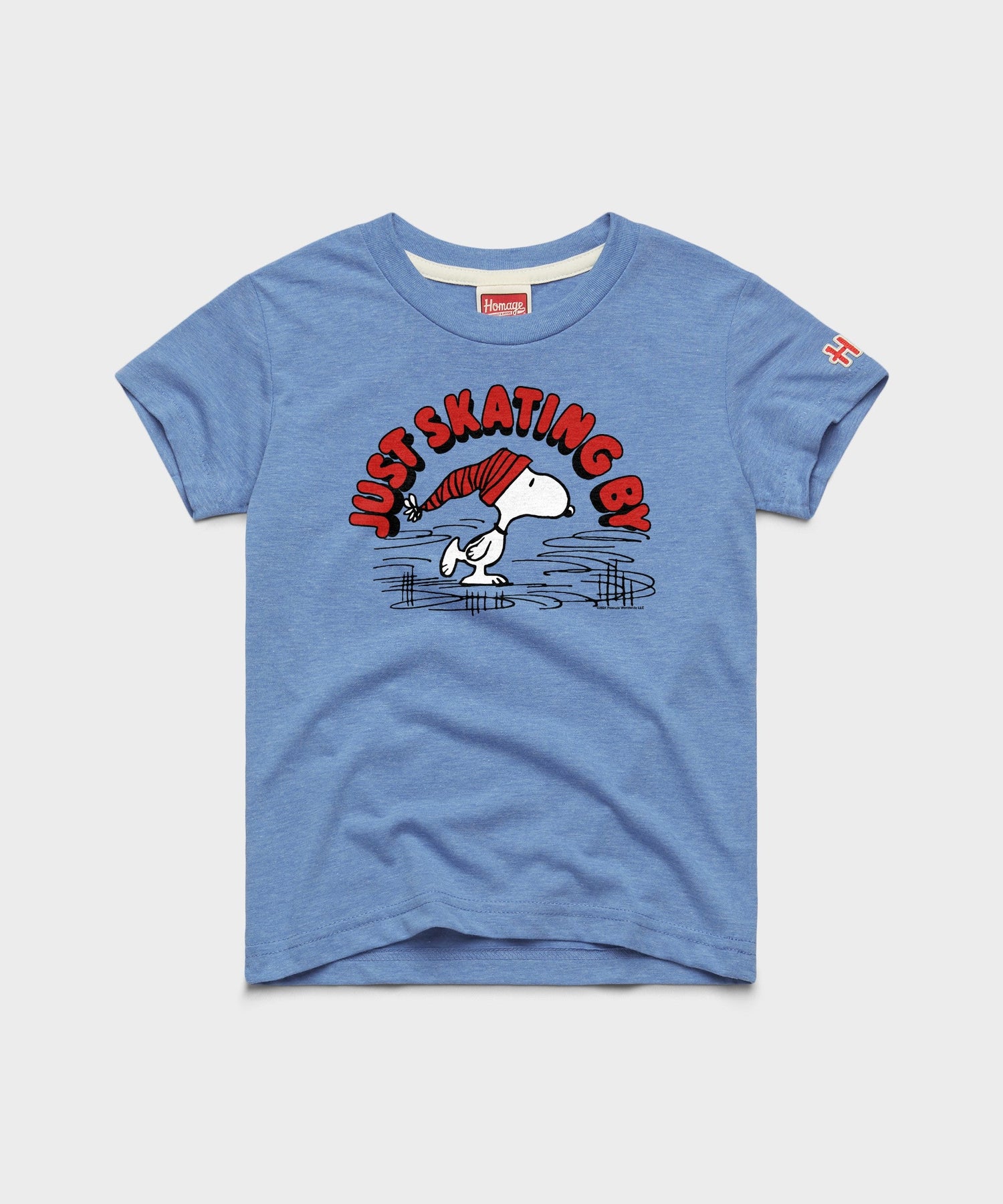 Light blue youth t-shirt featuring Snoopy skating across a frozen pond on the front chest