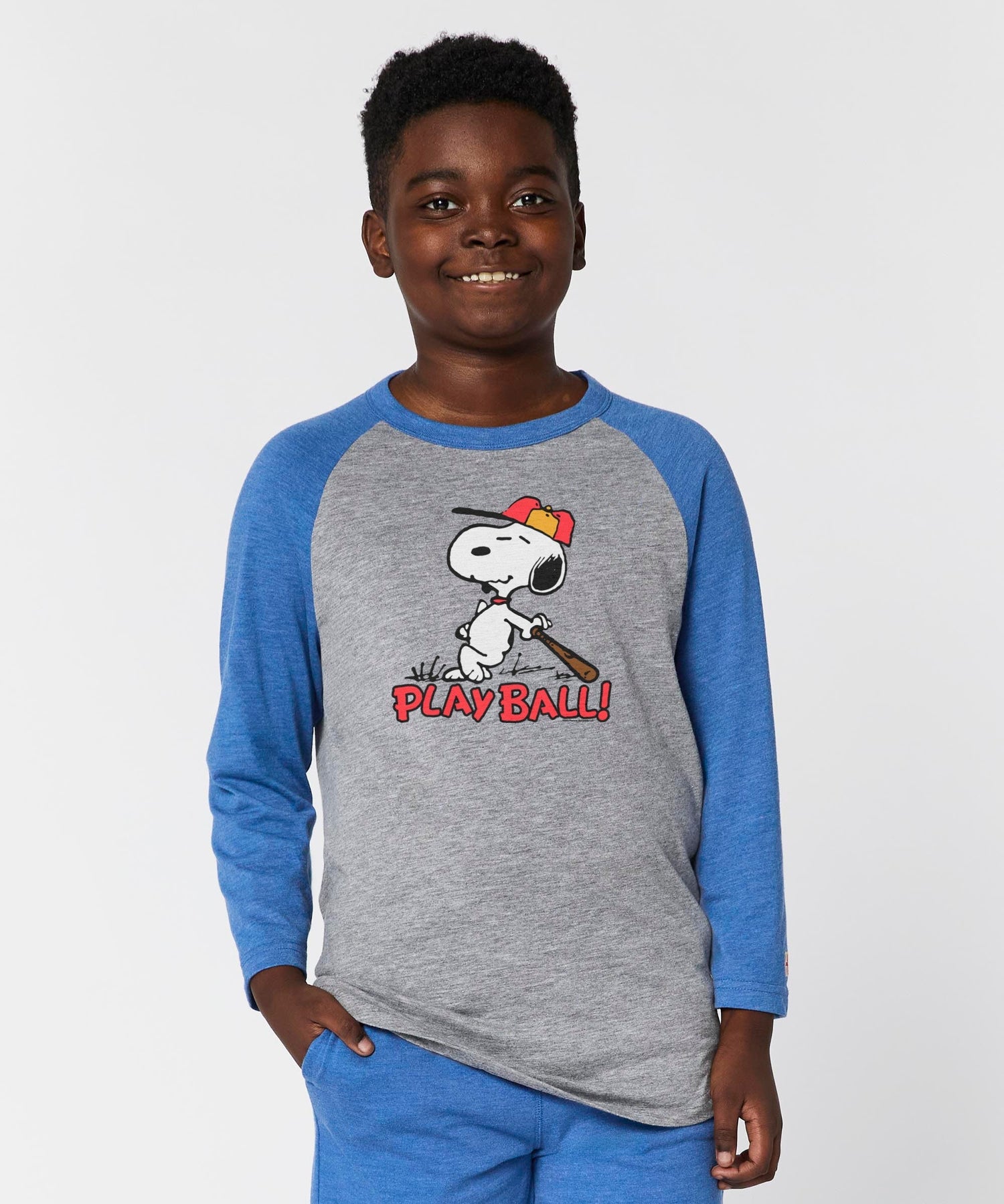 Side view of the youth raglan t-shirt showing the royal blue sleeves