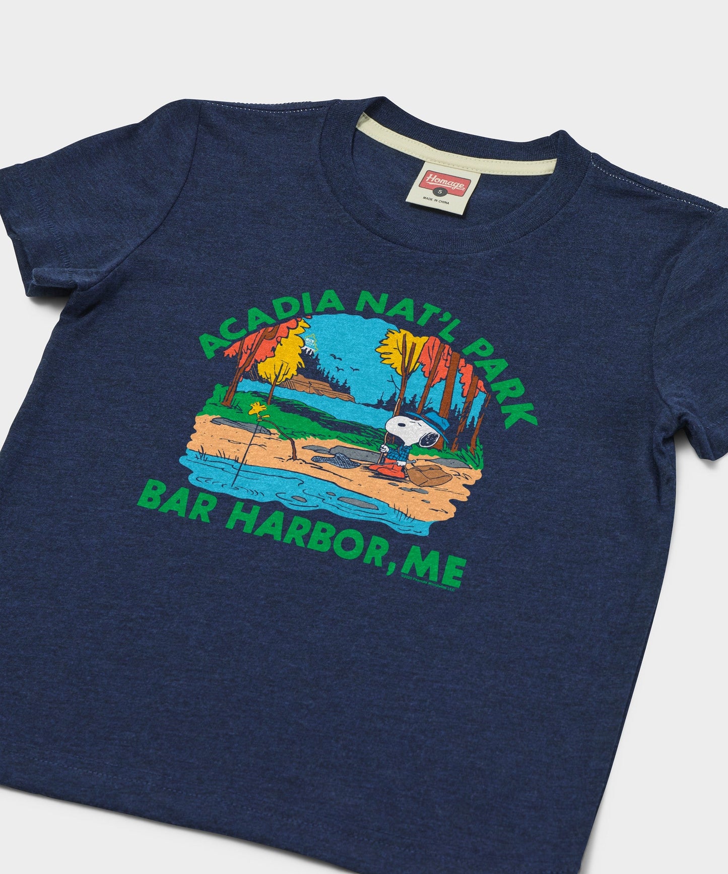 Close-up of the Snoopy and Acadia National Park graphic printed on the soft navy fabric