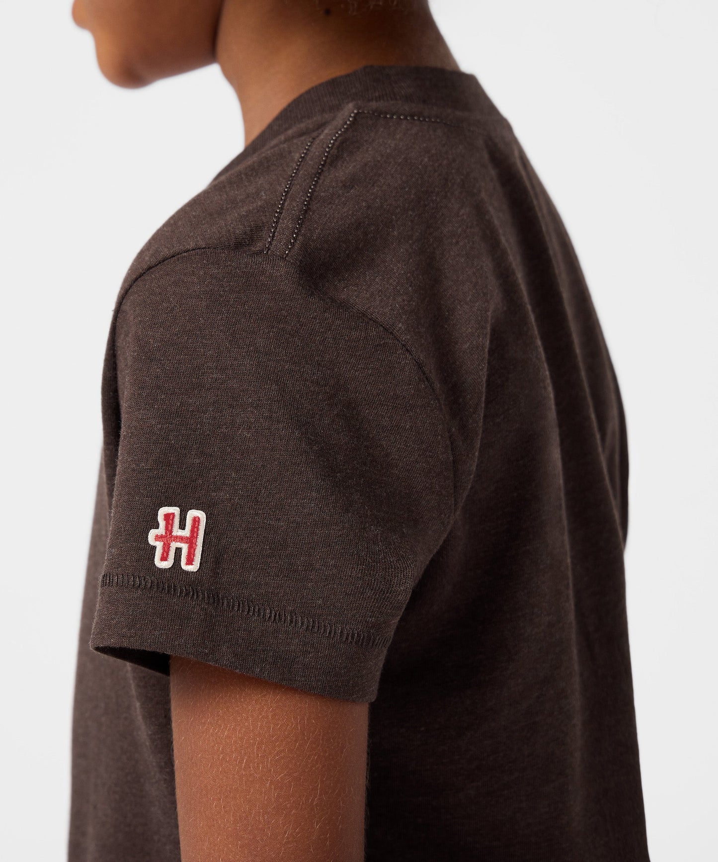 Folded brown youth t-shirt displaying the front graphic design