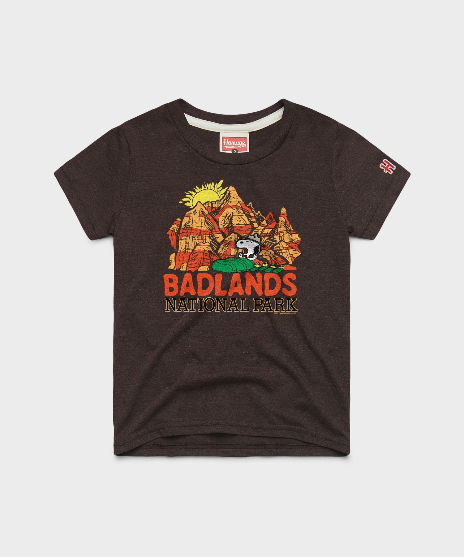 Brown youth t-shirt featuring Snoopy and the Peanuts gang exploring Badlands National Park on the front chest