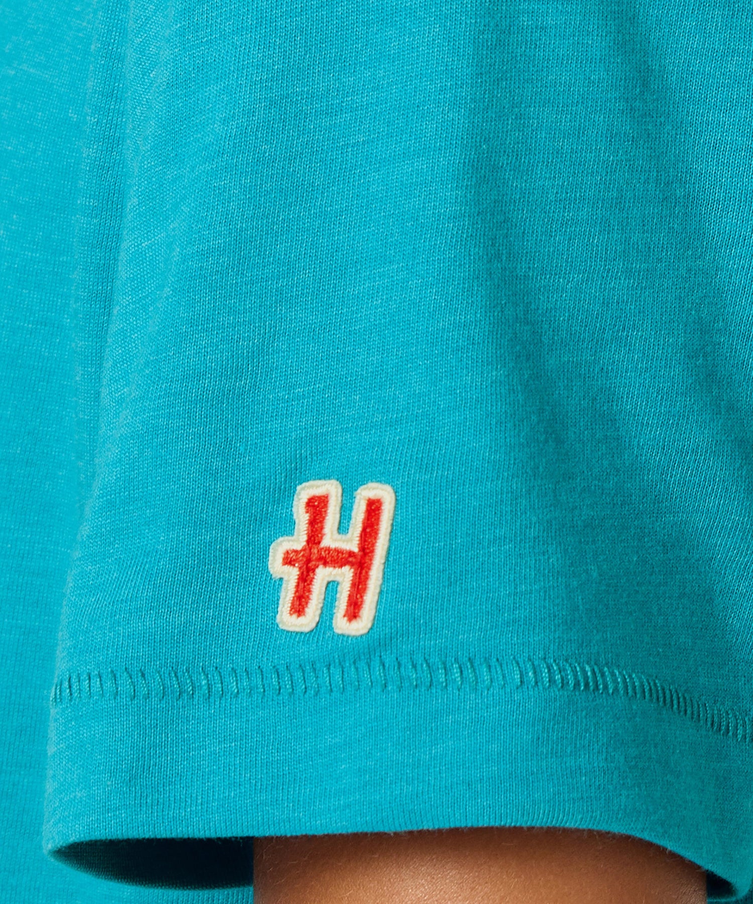 Detailed view of the soft cotton fabric texture in teal