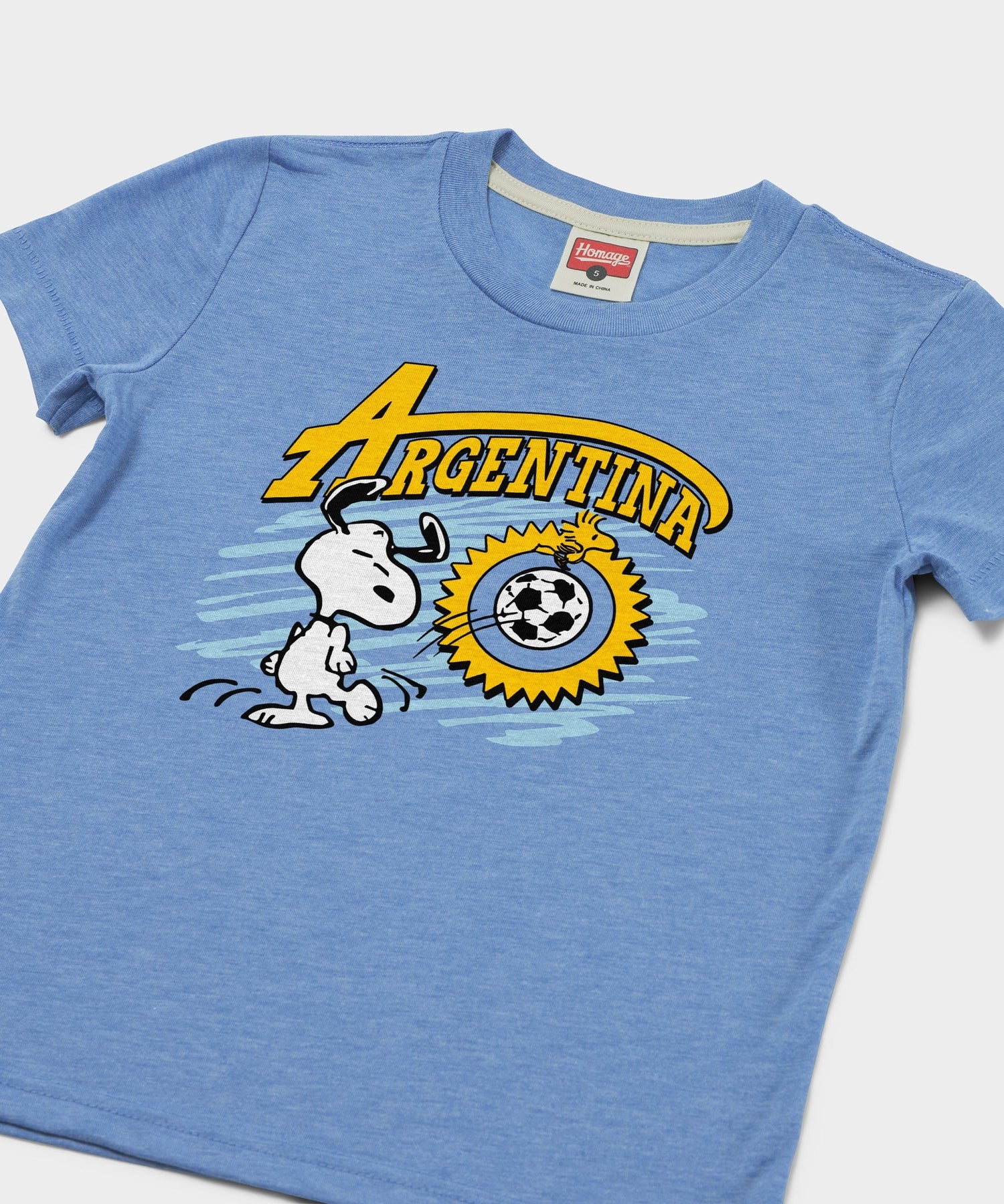 Close-up of the graphic showing Snoopy with Argentina soccer details on the light blue t-shirt