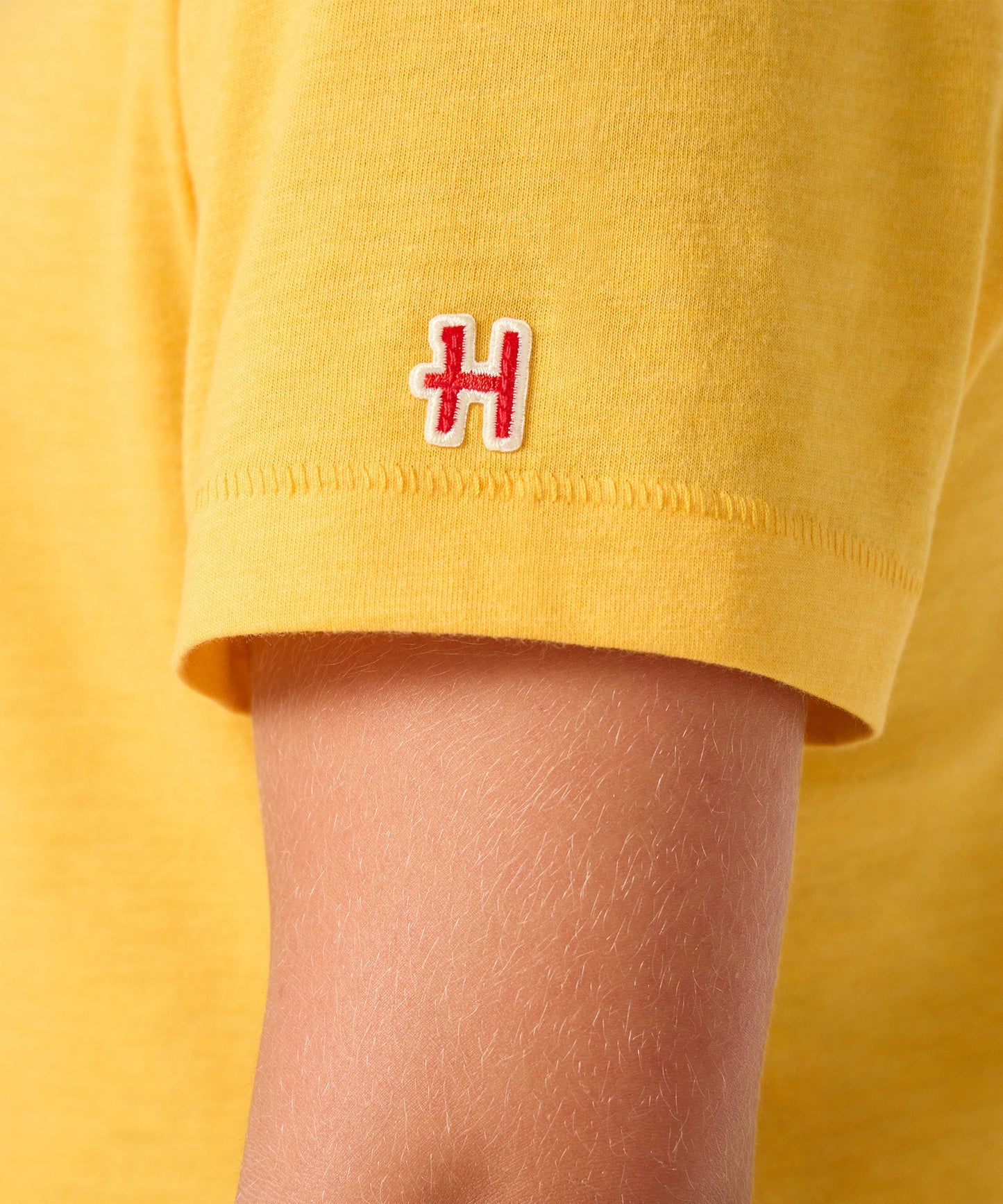 Folded view of the youth t-shirt showing the gold color
