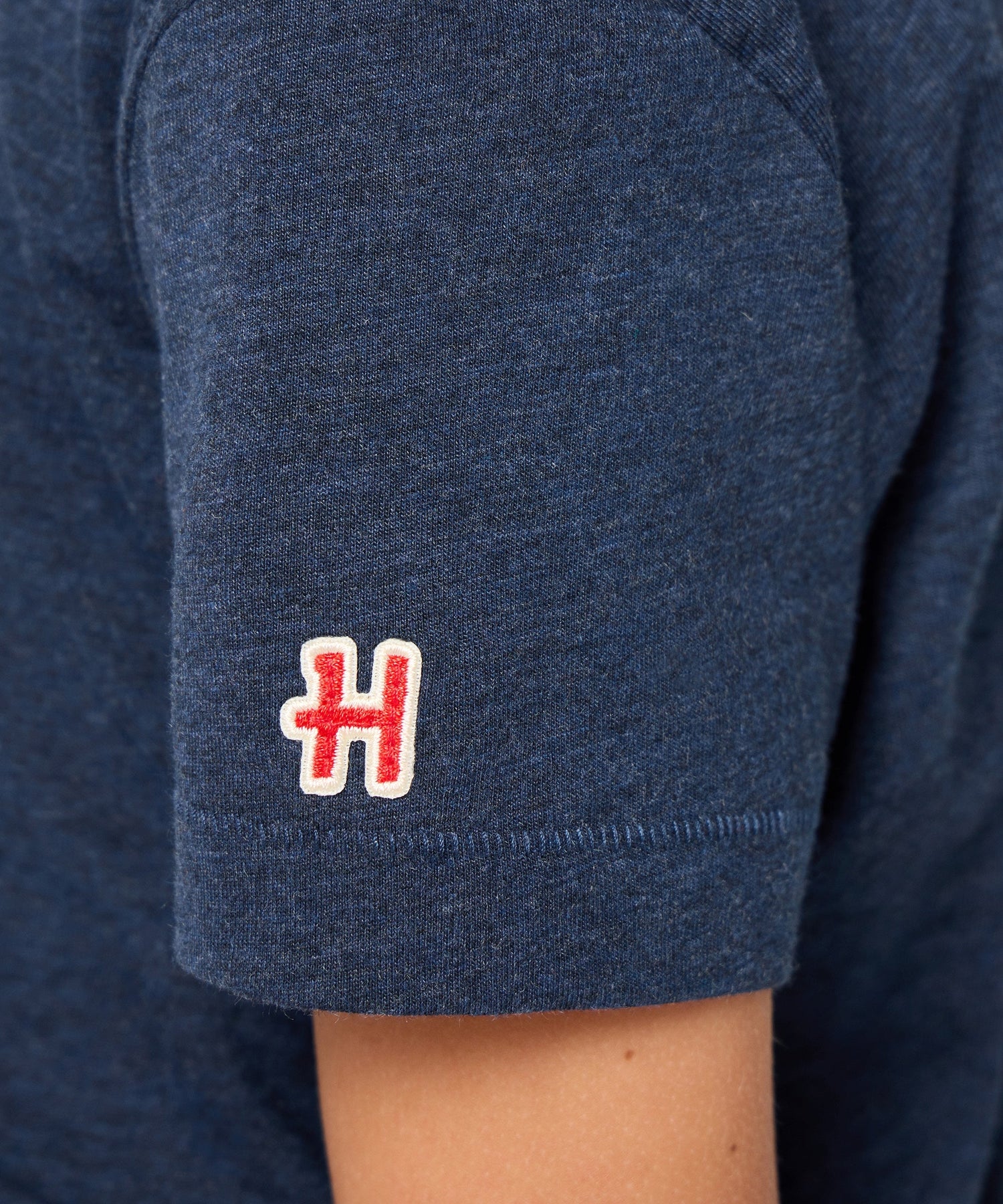 Folded view of the navy youth t-shirt showing the soft fabric texture