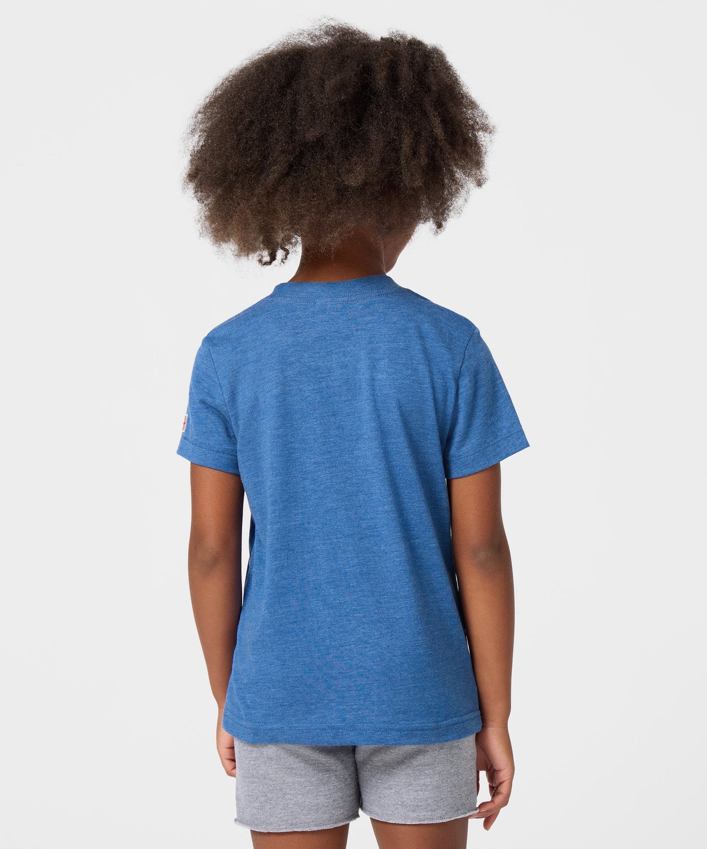 Close-up of the soft cotton fabric and collar tag of the youth t-shirt