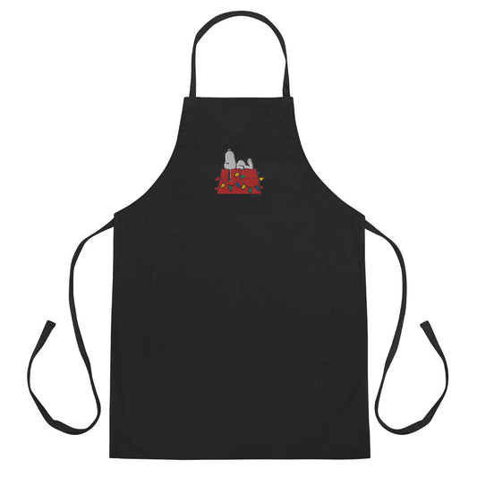 White kitchen apron featuring an embroidered graphic of Snoopy resting on his red doghouse-0