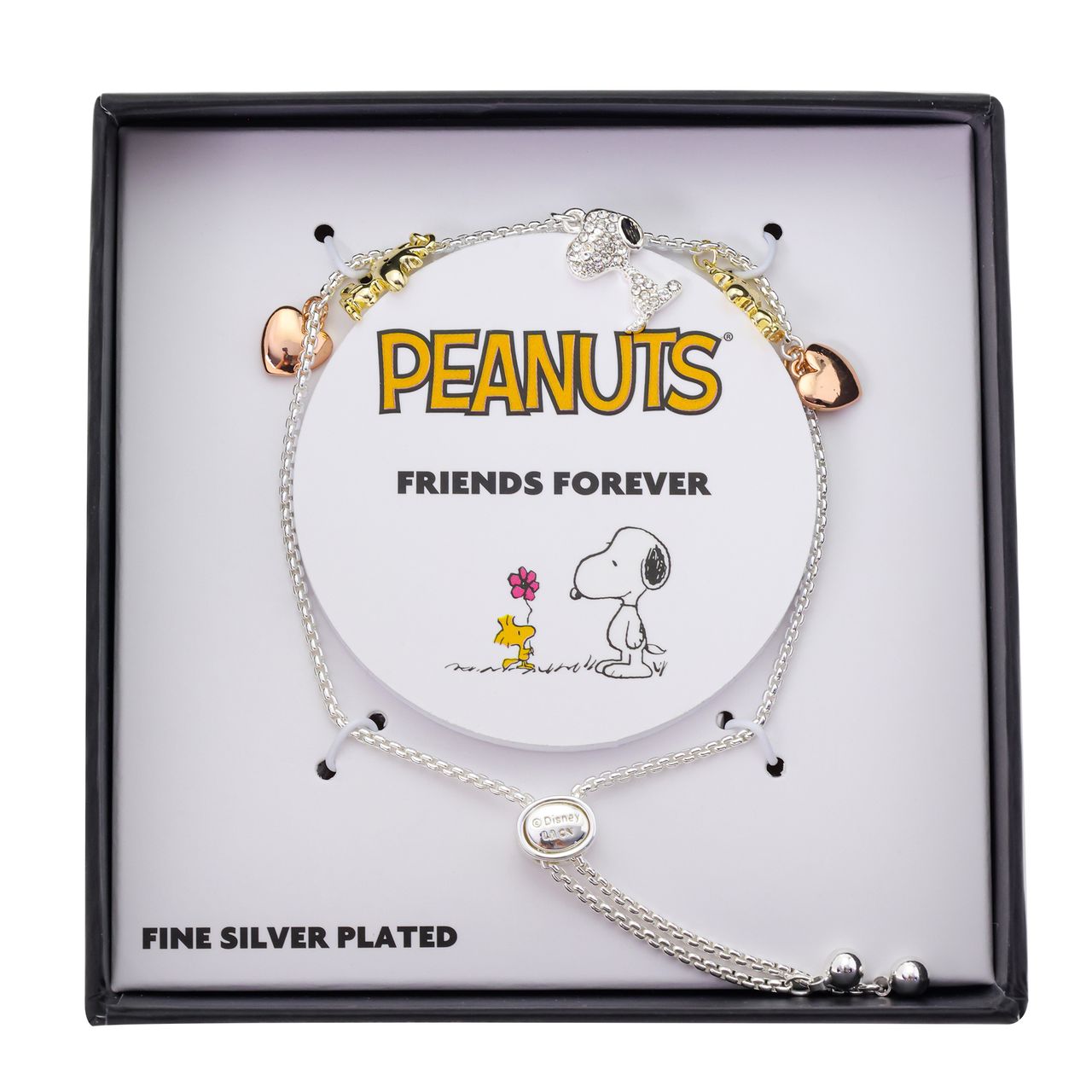 Angled view of the Peanuts Snoopy and Woodstock crystal bolo bracelet resting on a neutral surface