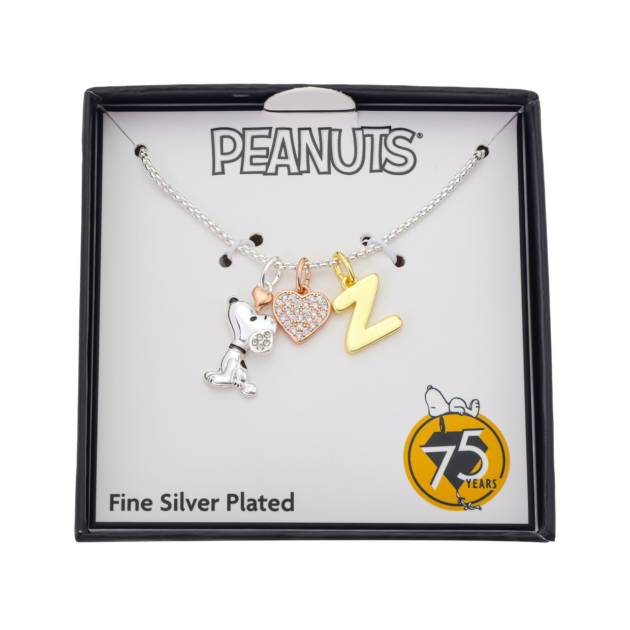 Flat lay view of the Peanuts charm necklace displayed against a neutral background
