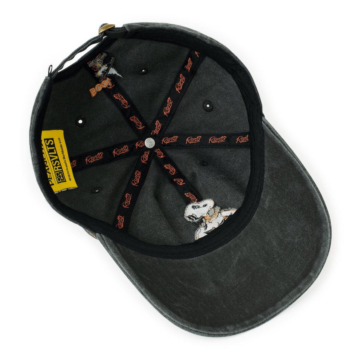 Side profile view of the Peanuts Dad Hat resting on a flat surface
